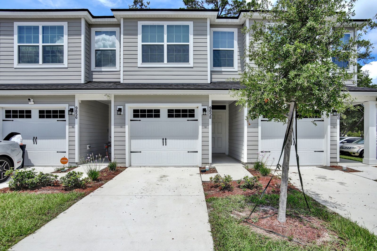 Townhome exteriors with garages and landscaped driveways at Morgan's Walk